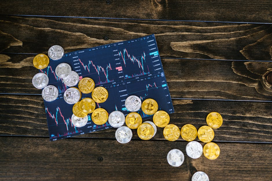 Gold and silver cryptocurrency coins scattered on a trading chart over a wooden table